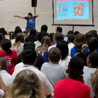  Students participating at a PBIS assembly in the gym